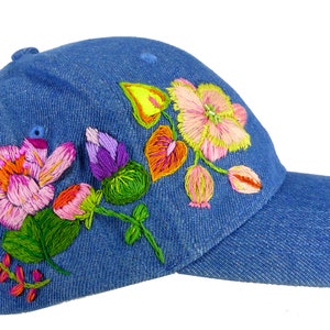 Hand embroidered denim baseball cap with Hawaiian flower theme. Hand designed and stitched with love with bead detail. One of a kind design