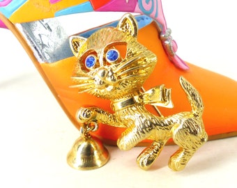 Coolest little gold raccoon  with a working tiny bell brooch pin with brilliant blue crystal eyes. Latch pin back. Comes gift packaged