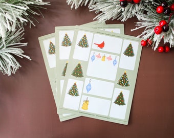 Puede incluir: Una hoja de pegatinas de árboles de Navidad con un cardenal rojo, adornos y una campana. La hoja de pegatinas es verde y blanca con el texto "Holiday Magic Designs Sticker Sheet".