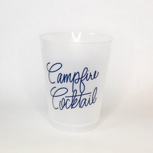 May include: A white plastic cup with the text "Campfire Cocktail" printed in blue.