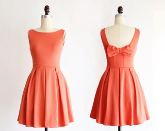 JANUARY | coral bridesmaid dress with bow + pockets. 1960s mod retro vintage style light poppy orange party dress. prom homecoming