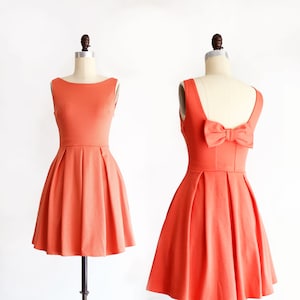 JANUARY | coral bridesmaid dress with bow + pockets. 1960s mod retro vintage style light poppy orange party dress. prom homecoming