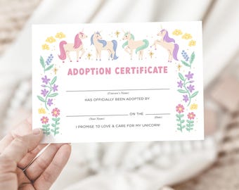 May include: A white adoption certificate featuring four colorful unicorns and floral accents. The text "ADOPTION CERTIFICATE" is in pink, with spaces to fill in the unicorn's name, adopter's name, and date. The certificate promises love and care.