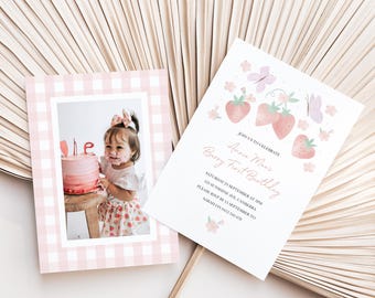 May include: A pink gingham-framed photo card featuring a child with a birthday cake, and a matching invitation with strawberry and butterfly illustrations. The invitation text reads "Annie Mai's Berry First Birthday".