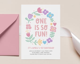 May include: A white invitation card with a floral wreath design and the text "ONE IS SO FUN!". The invitation is for April's 1st birthday and includes event details. A pink envelope is visible on the left.