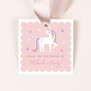 May include: Pink thank you tag with a white unicorn with a rainbow mane and tail. The tag has white stars and pink hearts on a pink background. The text on the tag reads "Thank you for coming to Mikaela's Party!"