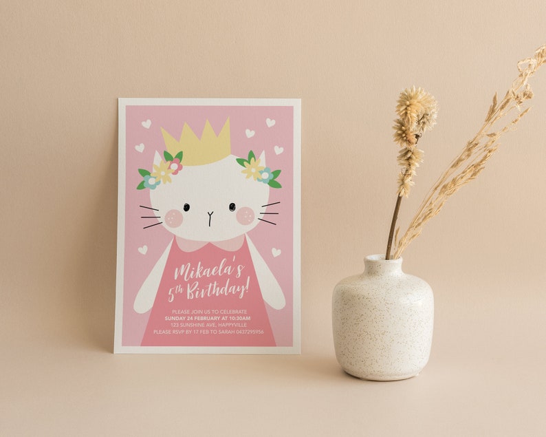 Może przedstawiać: R&oacute;żowe zaproszenie na urodziny z kresk&oacute;wkowym kotem w koronie i kwiatami. Tekst brzmi "Mikaela's 5th Birthday!" i zawiera szczeg&oacute;ły dotyczące przyjęcia.