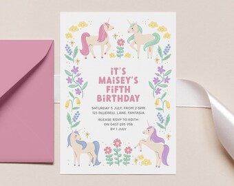 May include: A birthday invitation with a pink envelope and white ribbon. The invitation features four cartoon unicorns and the text "IT'S MAISEY'S FIFTH BIRTHDAY". Floral and star accents surround the text and unicorns.