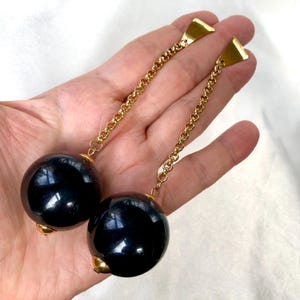 May include: A set of three ceramic mugs with a speckled, matte finish in cream, light grey, and dark grey. Each mug has a simple, minimalist design and a rounded handle.