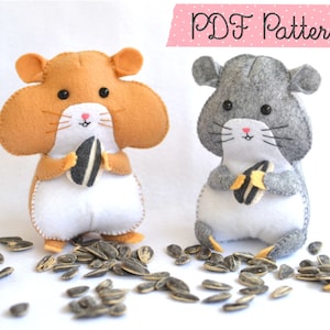 Op de afbeelding: Twee vilt hamster speelgoedjes die zonnepitten vasthouden. De hamster links is bruin en de hamster rechts is grijs.  PDF Patterns.