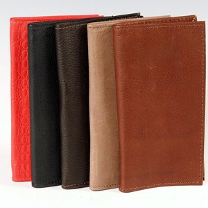 May include: Five leather wallets in different colours, including red, black, brown, beige, and brown. The wallets are lined up in a row, with the red wallet on the left and the brown wallet on the right.