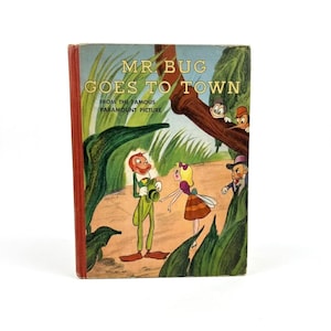 May include: Vintage hardcover book titled "Mr. Bug Goes to Town" from the Paramount Picture. The cover features cartoon illustrations of characters in a forest setting, with the title in gold lettering and a red spine.