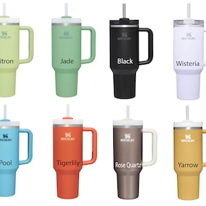 May include: Eight stainless steel travel mugs with different colored lids and handles. The mugs are labeled with the following colors: Citron, Jade, Black, Wisteria, Pool, Tigerlily, Rose Quartz, and Yarrow.