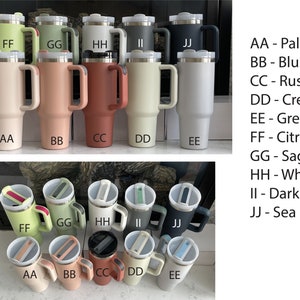 May include: Ten stainless steel travel mugs with different colored lids and handles. The mugs are arranged in two rows of five. The colors of the mugs are pale, blush, rust, cream, grey, citron, sage, white, dark grey, and sea.