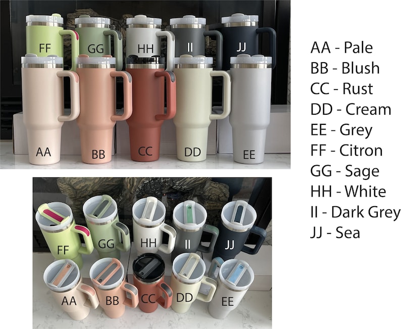 May include: Ten stainless steel travel mugs with different colored lids and handles. The mugs are arranged in two rows of five. The colors of the mugs are pale, blush, rust, cream, grey, citron, sage, white, dark grey, and sea.