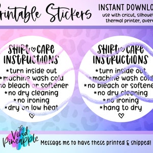 May include: Two printable sticker designs with a pink and purple background. The stickers are round and feature white text that reads "Shirt Care Instructions" with a list of care instructions for shirts. The text includes "turn inside out", "machine wash cold", "no bleach or softener", "no dry cleaning", "no ironing", and "dry on low heat" or "hang to dry".