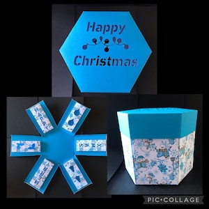 May include: A blue hexagonal box with a cut-out design that reads "Happy Christmas". The box is open to reveal six blue panels with different Christmas-themed designs, including a snowman, a Christmas tree, and the words "Merry Christmas".