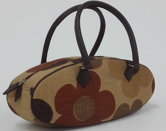 Brown floral printed canvas oval shape bag, top handle bag.