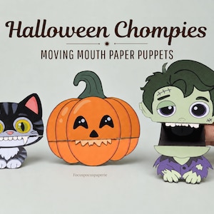 Könnte beinhalten: Drei Papierpuppen mit der Aufschrift Halloween Chompies Moving Mouth Paper Puppets. Die Puppen zeigen eine schwarz-graue Katze mit Fangzähnen, einen orangefarbenen Kürbis mit einem Jack-o'-Lantern-Gesicht und einen grünen Zombie.