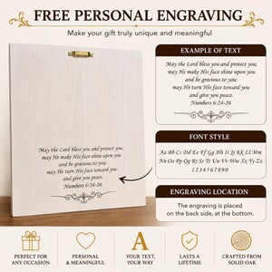 May include: A square light-colored wooden plaque featuring a gold-tone metal hanger on the back. The surface displays engraved text reading: May the Lord bless you and protect you; may He make His face shine upon you and be gracious to you.