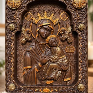 May include: A rectangular wooden wall plaque featuring a relief carving of the Virgin Mary holding the Christ child. The dark brown wood is accented with gold-toned highlights on the figures, halos, and ornate border, including the text IC XC.