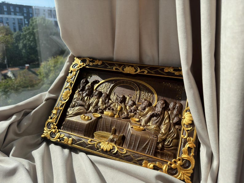 May include: A framed wood carving depicting the Last Supper. The carving is painted in brown and gold tones and features a detailed scene of Jesus and his disciples gathered around a table.