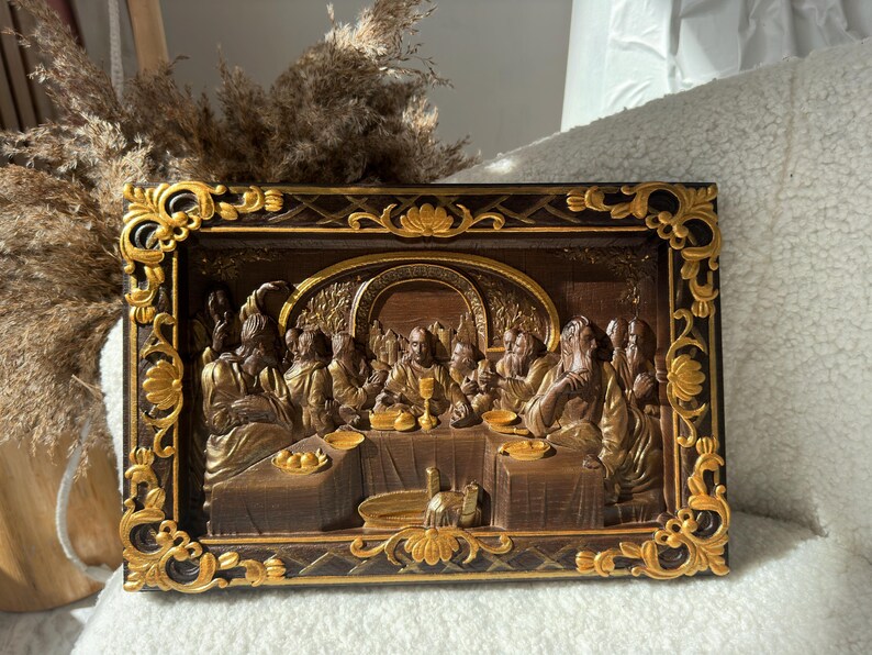 May include: A framed wood carving depicting the Last Supper. The carving is painted in gold and brown tones and features a detailed depiction of Jesus and his disciples.