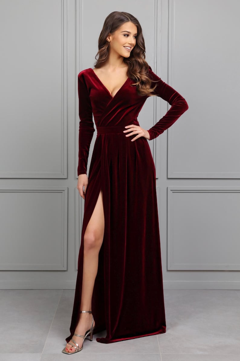 burgundy velvet maxi dress with slit, long sleeve velvet formal gown, fall wedding guest velvet dress, winter burgundy evening gown, elegant velvet bridesmaid dress, modest long sleeve formal dress, velvet gown for holiday party, deep v velvet maxi dress, romantic wedding guest outfit, classy velvet evening dress