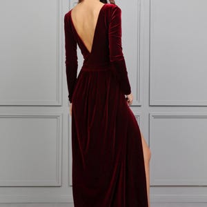 burgundy velvet maxi dress with slit, low back dress, backless dress, long sleeve velvet formal gown, fall wedding guest velvet dress, winter burgundy evening gown, elegant velvet bridesmaid dress, modest long sleeve formal dress, velvet gown for holiday party, deep v velvet maxi dress, romantic wedding guest outfit, classy velvet evening dress