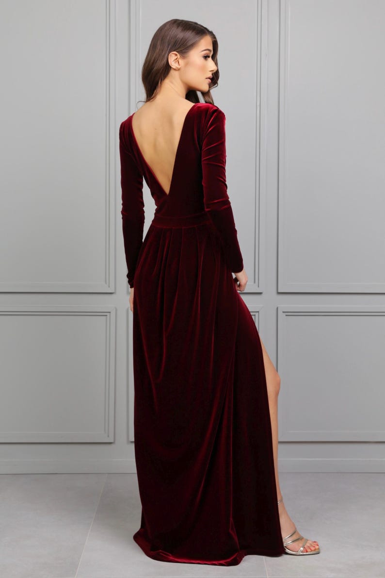 burgundy velvet maxi dress with slit, low back dress, backless dress, long sleeve velvet formal gown, fall wedding guest velvet dress, winter burgundy evening gown, elegant velvet bridesmaid dress, modest long sleeve formal dress, velvet gown for holiday party, deep v velvet maxi dress, romantic wedding guest outfit, classy velvet evening dress
