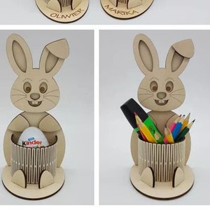 May include: Six wooden bunny pencil holders with names on the base. Two additional bunny pencil holders, one with a Kinder egg and the other with pencils.