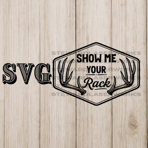 May include: Black and white SVG design with the text "SVG" on the left and a hexagonal emblem on the right. The emblem reads "SHOW ME YOUR Rack" with antler illustrations. The background is a light wood grain.