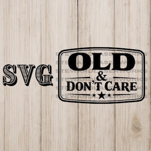 May include: Black and white SVG design with the text "OLD & DON'T CARE" in a rectangular frame, and the word "SVG" to the left. The design is on a light brown wooden background.
