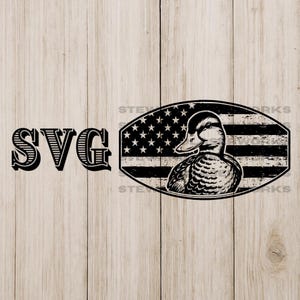 May include: Black and white graphic featuring a duck inside an oval with the American flag design. The word "SVG" is to the left of the oval. The image is on a light wood grain background.