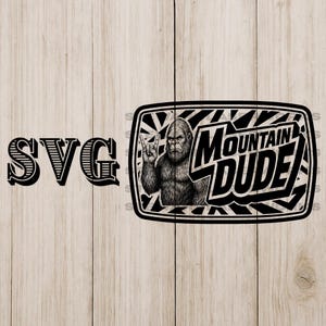 May include: Black and white SVG design featuring a Bigfoot illustration giving a rock and roll hand gesture. The text "Mountain Dude" is displayed in a bold, stylized font within a rectangular frame. The word "SVG" is on the left.