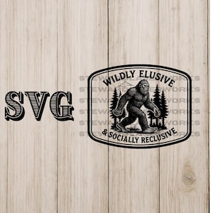 May include: Black and white graphic featuring a Bigfoot illustration walking through a forest, with the text "WILDLY ELUSIVE & SOCIALLY RECLUSIVE". The letters "SVG" are on the left side of the image.
