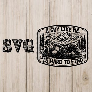 May include: Black and white SVG design featuring a relaxed Bigfoot illustration within a rectangular frame. The frame includes text that reads "A Guy Like Me Is Hard To Find" with a mountain and forest backdrop.