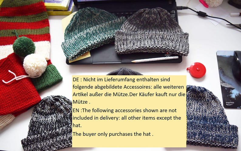 May include: Several knitted beanies in shades of gray, green, and blue are displayed. The hats have a textured appearance. A red and white scarf with pom-poms is also visible. The image includes text in German and English.