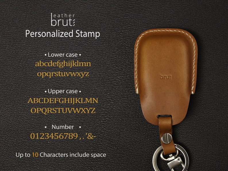 May include: A brown leather key fob with a stitched edge and the word "brut" embossed on the front. The fob has a silver key ring attached. The image shows a personalized stamp option with lowercase and uppercase letters, numbers, and symbols. The text reads "Up to 10 Characters include space".