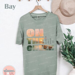 90s inspired nostalgia graphic tee on Comfort Colors shirt, coastal sunset watercolor artwork, popular vintage style clothing. Dawsons Creek