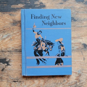 May include: A blue book with the title "Finding New Neighbors" on the cover. The cover features an illustration of two people on horseback.