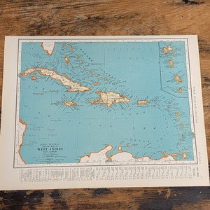 May include: A vintage map of the West Indies, showing the islands of Cuba, Jamaica, Hispaniola, Puerto Rico, and the surrounding smaller islands. The map is printed on blue paper with brown lines and text. The title "Rand McNally Popular Map West Indies" is printed in the bottom left corner.