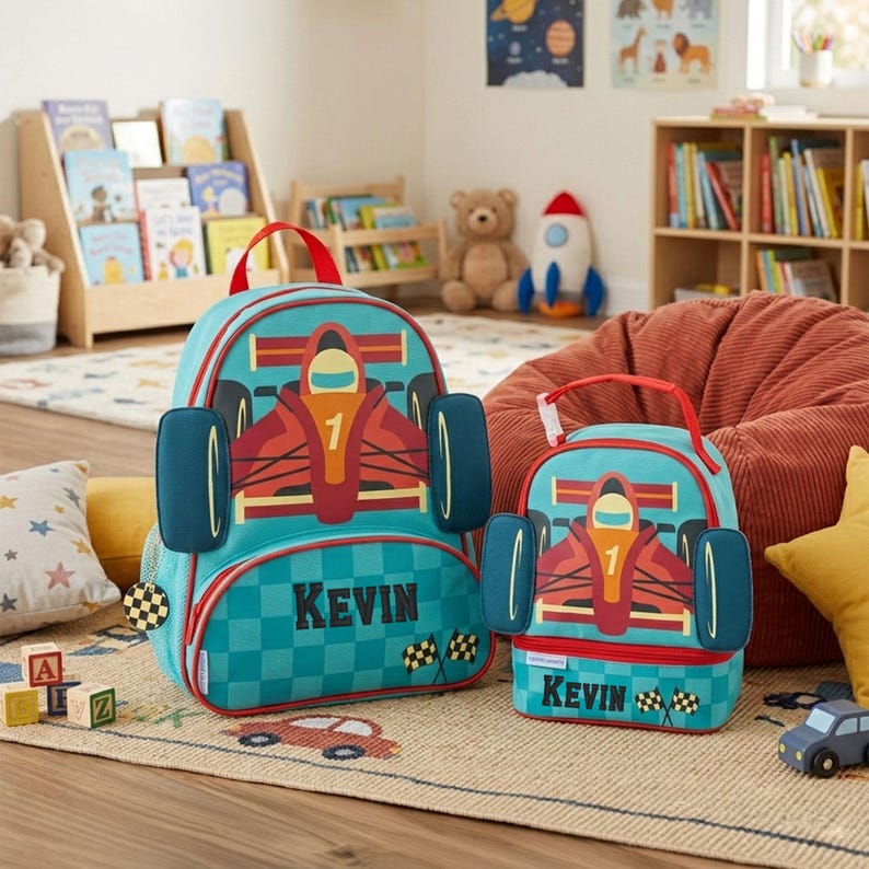 May include: A teal backpack and matching lunch bag featuring a red race car graphic with the number 1, a checkered pattern, and the name KEVIN printed in black. Both items have red handles, side accents, and checkered flag details.