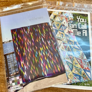 May include: Two quilting pattern books, one titled "You Can Call Me All" with a colorful quilt design on the cover, and the other titled "smithereens" with a black background and a colorful geometric pattern.