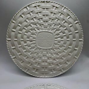 May include: A set of three ceramic canisters with lids. The canisters are white with a blue floral pattern. The largest canister is 8 inches tall, the medium is 7 inches, and the smallest is 6 inches.