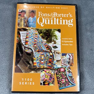 May include: DVD case for "Fons & Porter's Love of Quilting" 1100 Series. The cover shows two women, a quilt on a rocking chair, and other quilting examples. The case is orange with black text and images, and includes 13 episodes with tips.