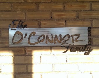 May include: A metal sign with the text "The O'Connor Family Est 2015" in a black script font on a silver background.