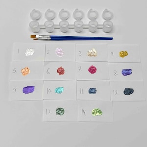May include: Paint color samples numbered 1 through 14 on white cards. The colors include white, silver, pink, gold, peach, red, magenta, purple, blue, teal, gray, black, green, and lime green.