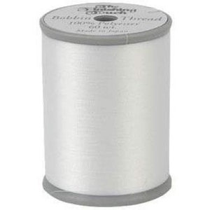 May include: A spool of white thread labeled "The Thread Exchange" with the text "Bobbin Thread 100% Polyester 60 wt." The spool has a gray top and bottom and is cylindrical in shape.