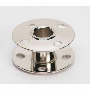 May include: A silver metal bobbin holder for a sewing machine. The holder has a round base and a raised center with a hole for the bobbin.